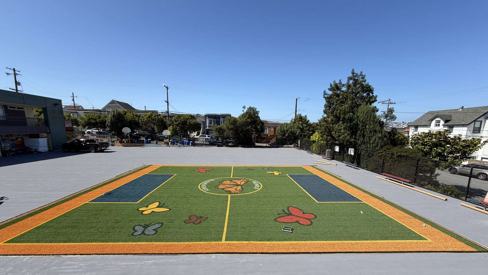 Monroe Elementary after: finished Pivot field with orange border and butterfly design under blue sky, San Francisco