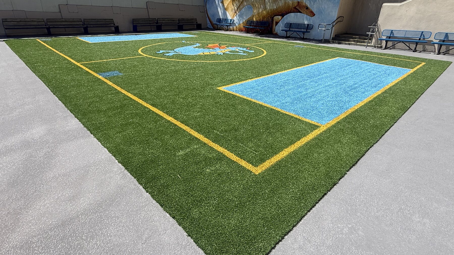Pivot soccer field at Thomas Edison Charter Academy with the school's dragon logo tufted into the center, San Francisco